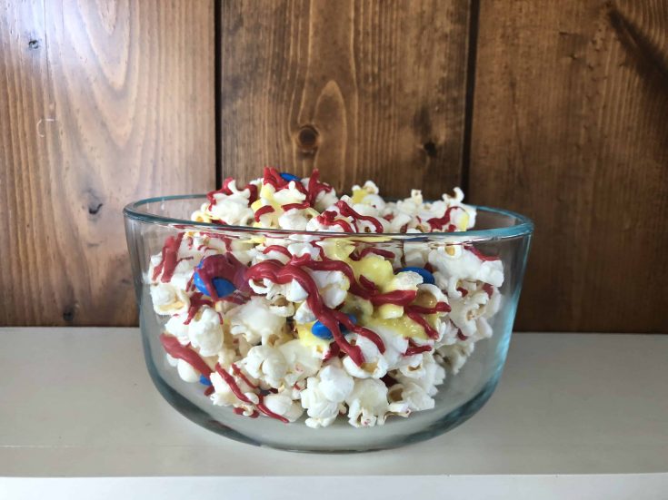 Looking for a fun new popcorn recipe for movie night? Check out this sweet Captain Marvel themed popcorn with red, blue and yellow -- the colors of the movie! #captainmarvel #disneyrecipes