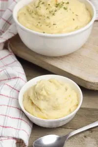 This crockpot mashed potatoes with cheddar recipe takes requires no boiling. It's perfectly delicious for thanksgiving or your next dinner party!