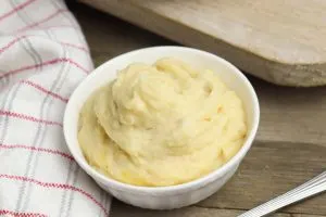 This crockpot mashed potatoes with cheddar recipe takes requires no boiling. It's perfectly delicious for thanksgiving or your next dinner party!