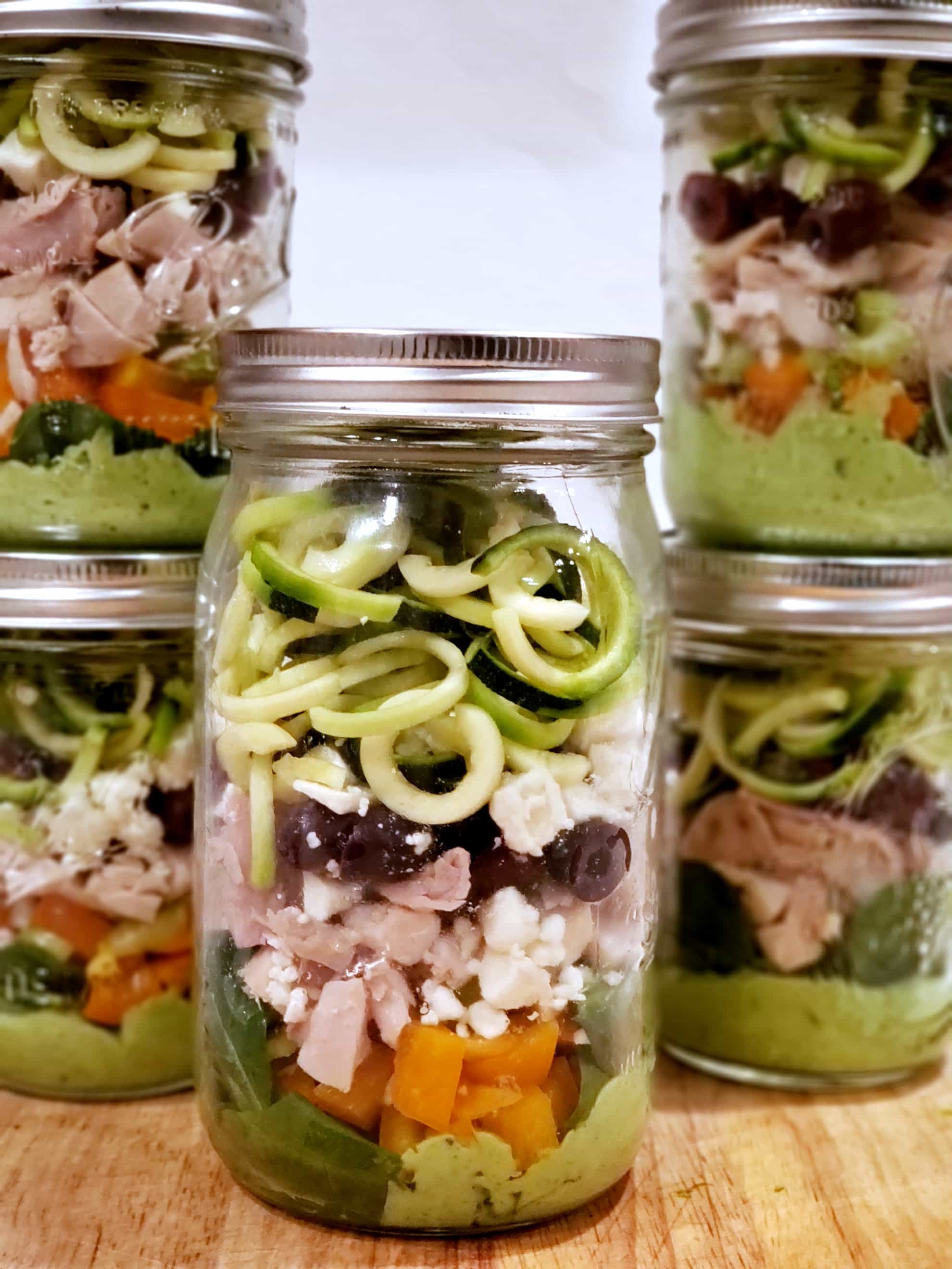 This Zucchini Noodle Salad with chicken recipe is fun to make and put in a mason jar for an easy healthy make ahead lunch for work. Clean eating made super easy with meal prepping. #mealprep #cleaneats