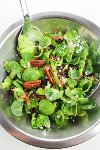 This incredibly easy brussels sprouts salad features pecans, bacon, cranberries and feta cheese! Impress your guests with this alternative to regular salad!