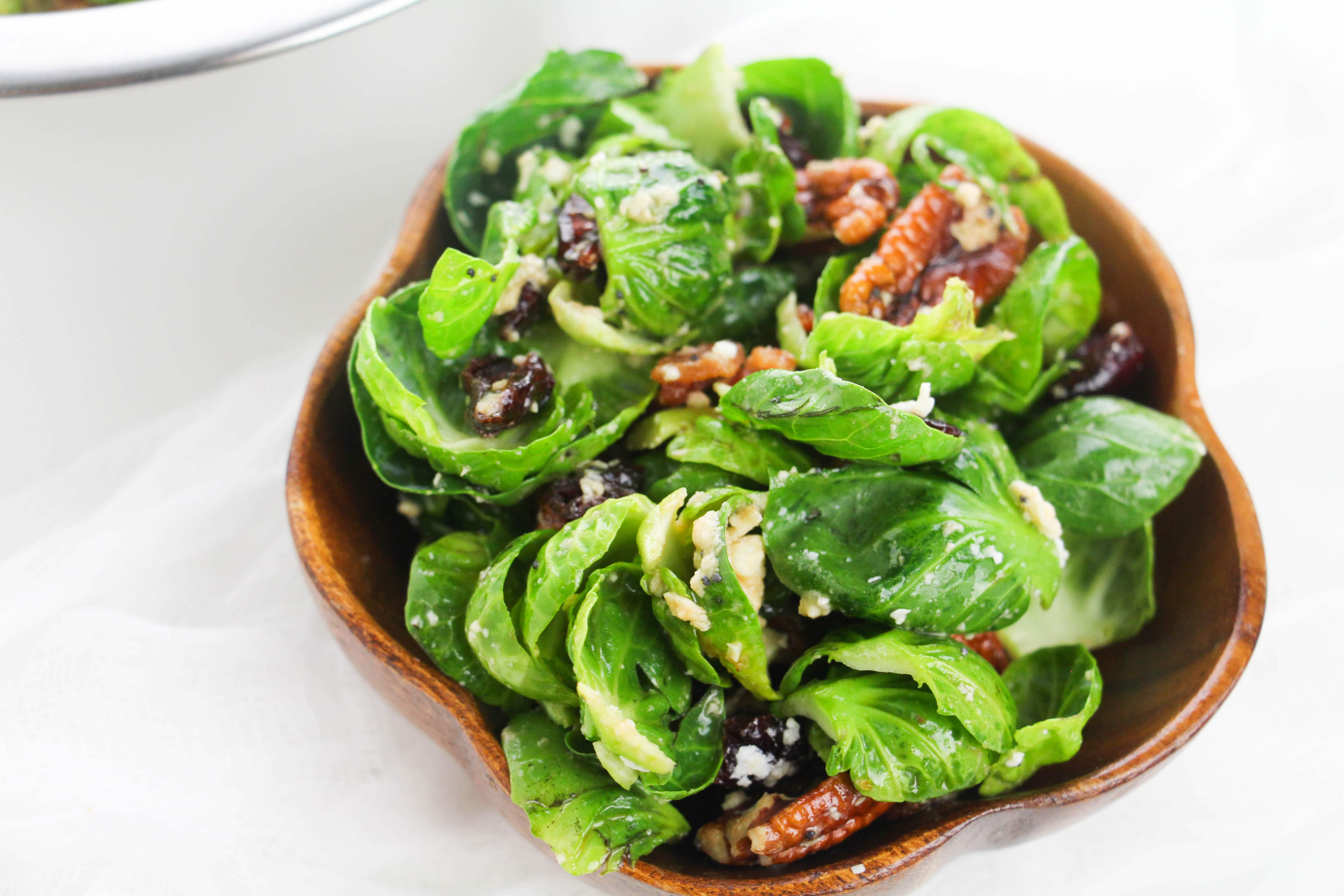 This incredibly easy brussels sprouts salad features pecans, bacon, cranberries and feta cheese! Impress your guests with this alternative to regular salad!