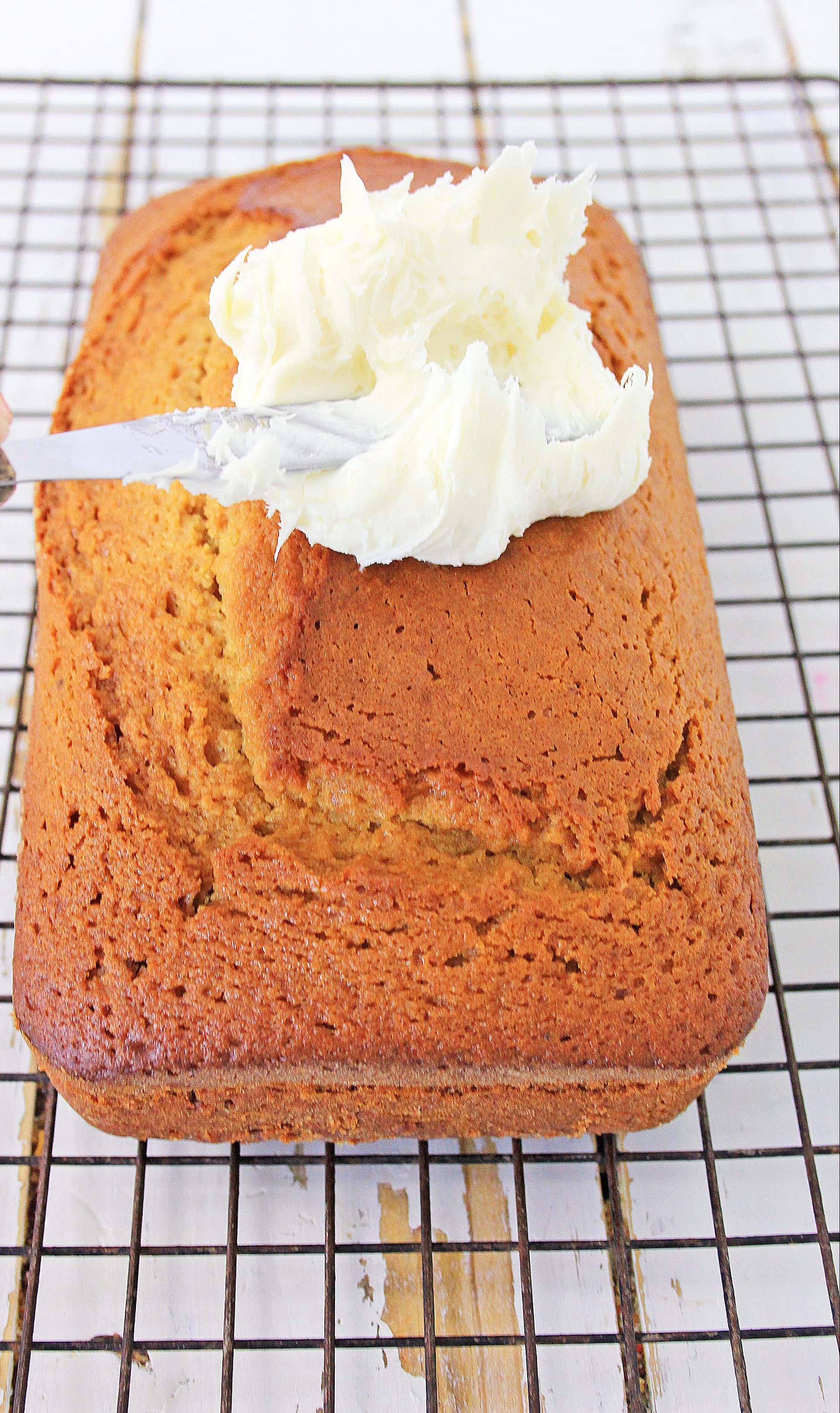 This Gingerbread Loaf with Cream Cheese Icing is perfect for holiday gifts or Christmas parties! Celebrate the season with this amazing recipe! #gingerbreadloaf
