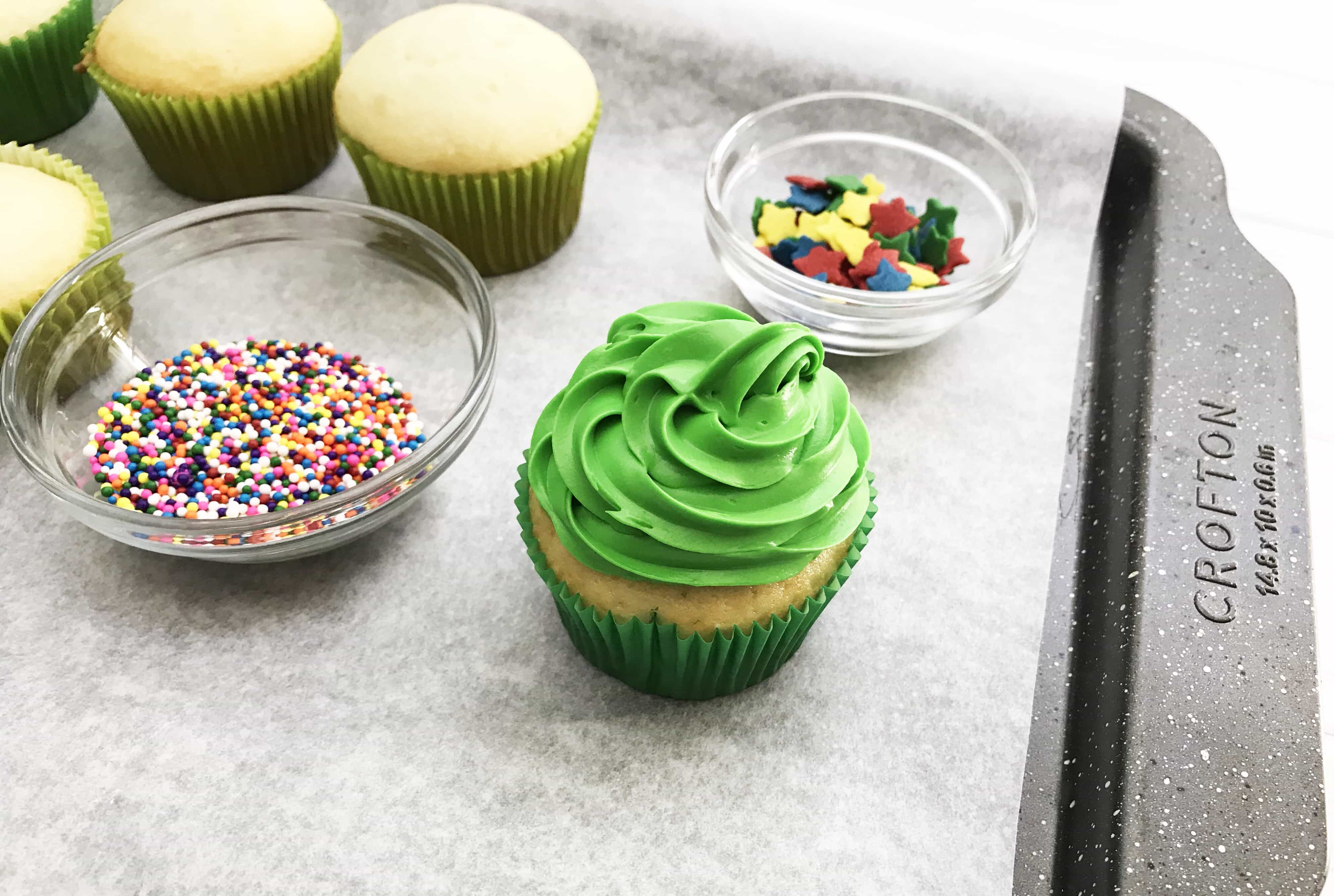 These Christmas Tree Cupcakes are so fun and festive! You can use store bought or your own homemade cupcake recipe for these delicious treats! They are perfect for holiday parties, bake sales and so much more. The pretty green color makes it super attractive to anyone!