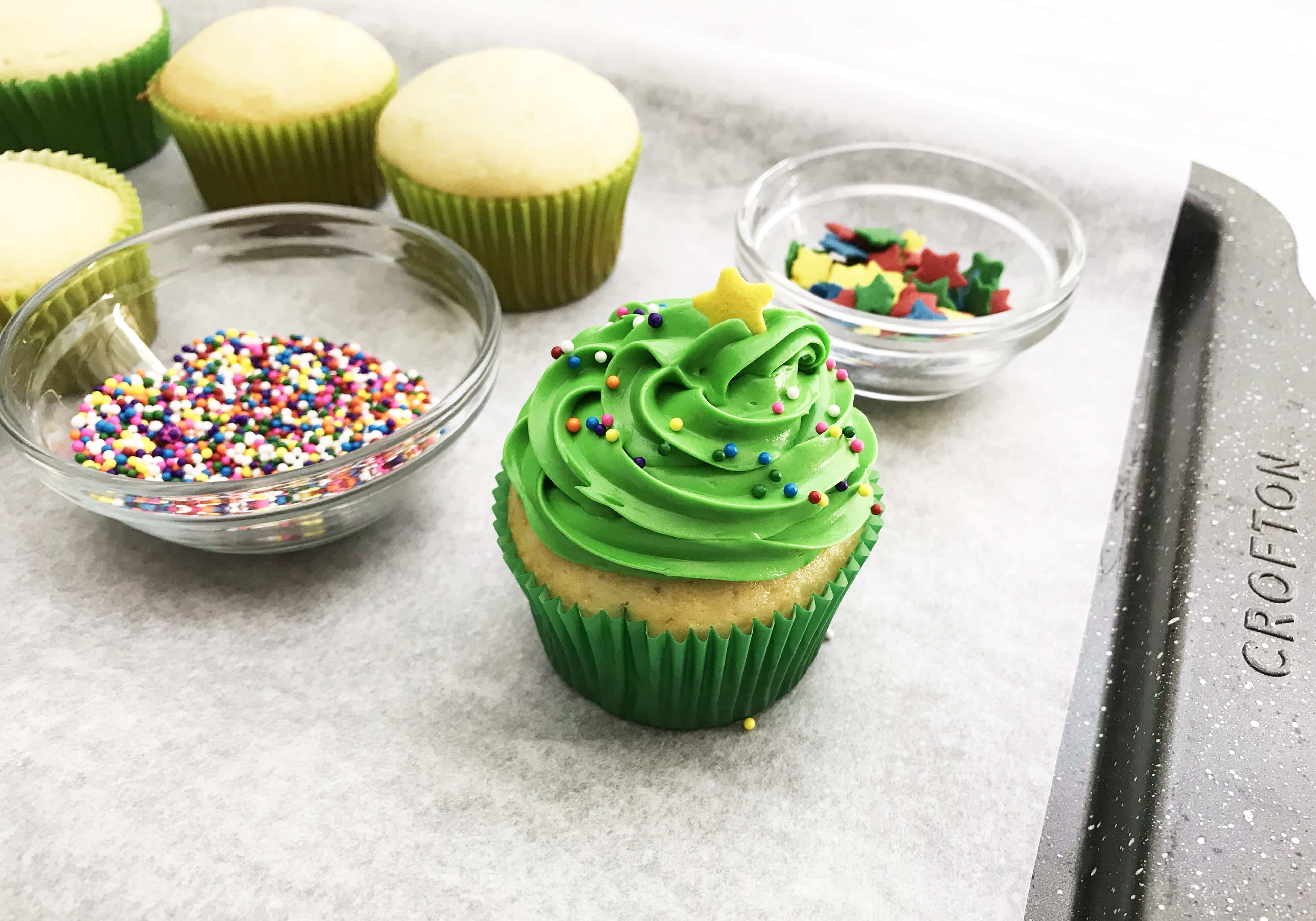 These Christmas Tree Cupcakes are so fun and festive! You can use store bought or your own homemade cupcake recipe for these delicious treats! They are perfect for holiday parties, bake sales and so much more. The pretty green color makes it super attractive to anyone!