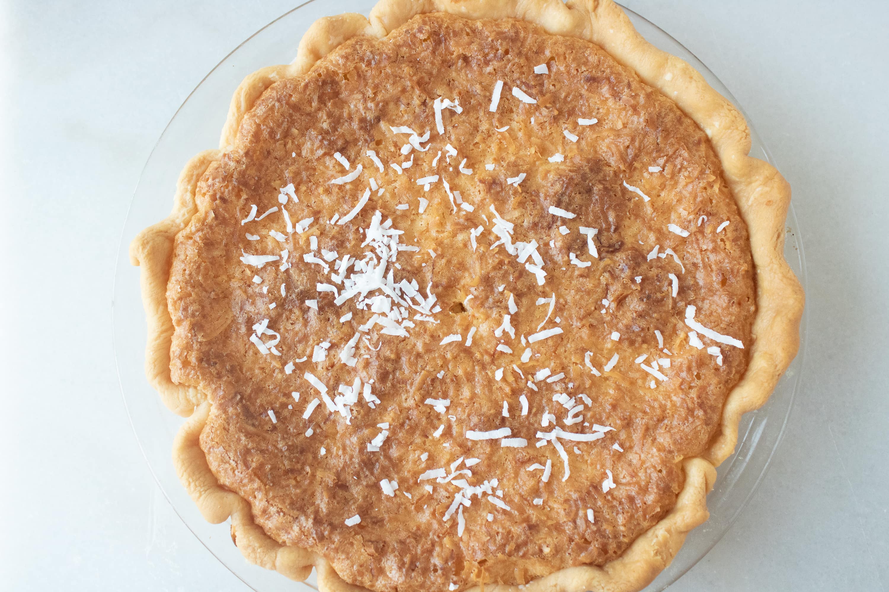 This coconut cream pie recipe features a yummy and creamy coconut filling, can be used with your favorite pie crust, and topped with coconut shavings. Perfect for Thanksgiving and anytime.