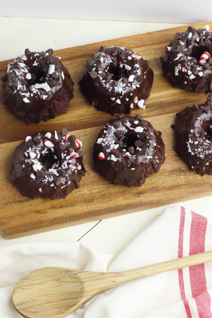 These chocolate peppermint mini bundt cakes are super easy to make! The easy recipe uses a combination of cake mix and frosting and crushed peppermint on top. This is a great recipe to make with kids! #baking #holidayrecipes #peppermint