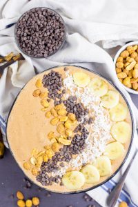 This Chocolate Peanut Butter Smoothie Bowl is quite healthy and it's a great way to feed your family breakfast or a treat that is full of nutrients! Full of amazing flavors and you can vary the toppings however you like! You can use granola, banana, coconut, chocolate chips and so much more. #healthyeating #smoothiebowl #breakfast #chocolatepeanutbutter