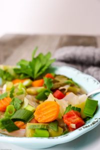 Check out this yummy and hearty homemade vegetable soup recipe filled with tons of nutrients and immunity building veggies! This vegetarian recipe will help fight the flu and is full of flavor! Easy to follow, you may already have all you need to make this yummy soup! #vegetablesoup #vegetarian #vegetables #healthyeating