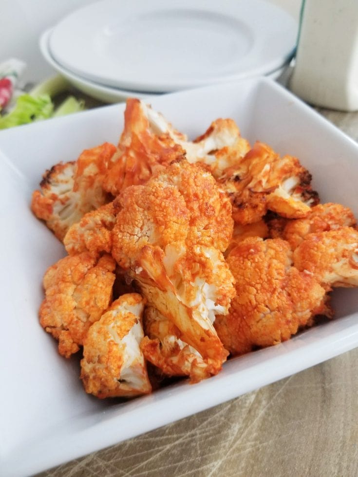 This super easy buffalo air fryer cauliflower recipe is so simple to make with only two ingredients! it is the perfect side dish or big game appetizer! #healthyappetizers #cauliflowerrecipe #vegetableappetizer