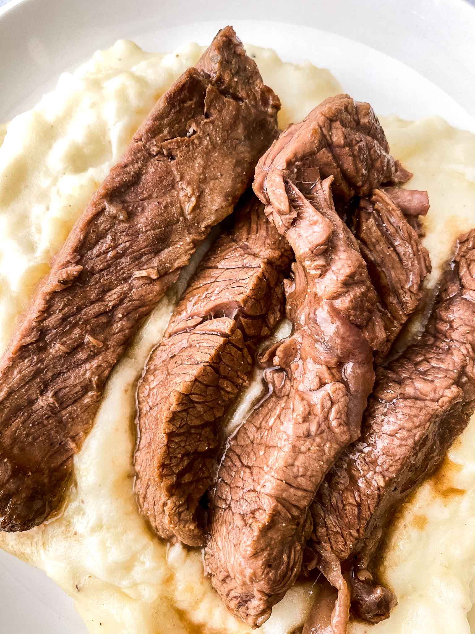 Crockpot Sirloin Steak on mashed potatoes