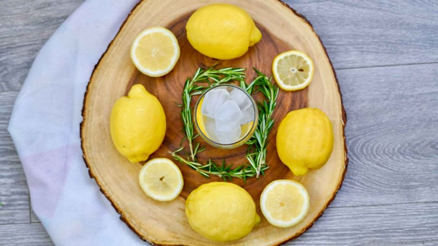 overhead shot of lemon spritzer cocktail with lemons surrounding the glass
