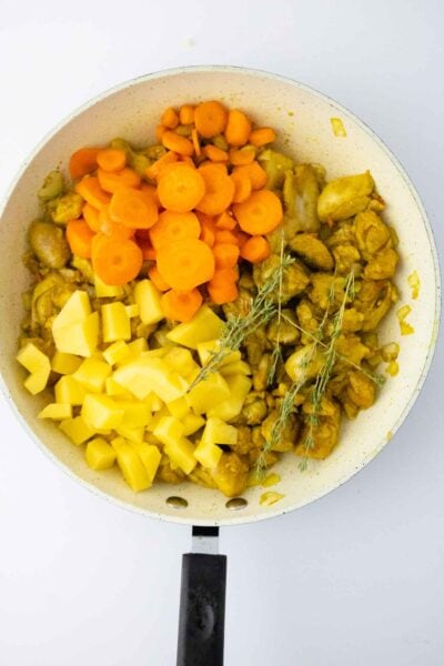 Authentic Jamaican Curry Chicken cooking in pan