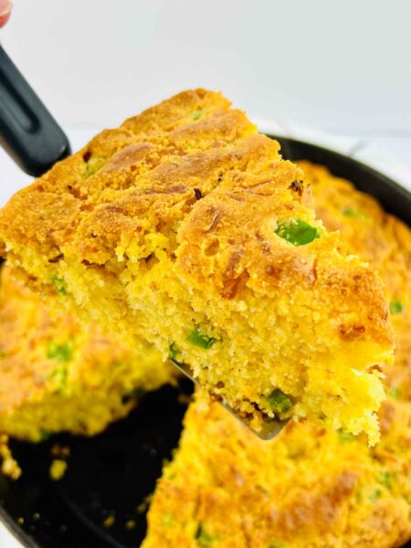 jalapeno cornbread slice being held up on a spatula
