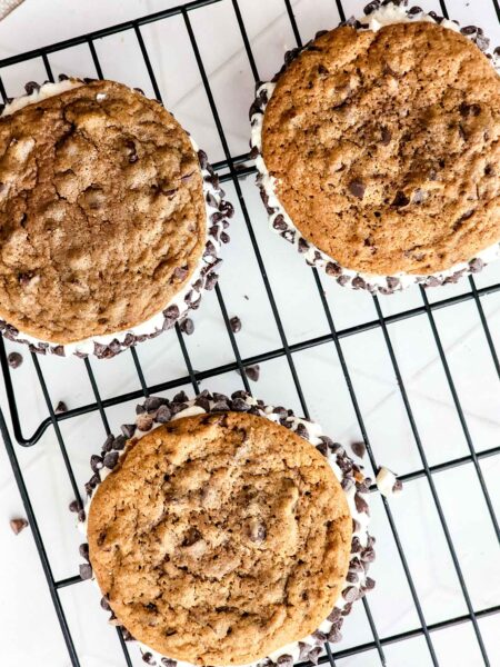 cannoli cookie sandwiches on a wire rack